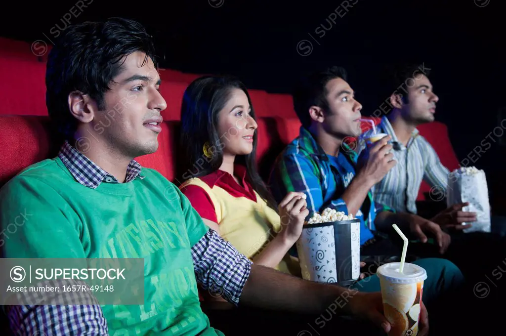 Friends enjoying movie in a cinema hall
