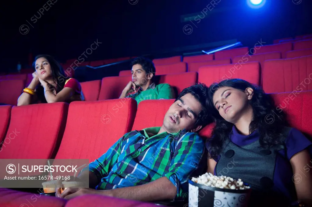 Couple sleeping in a cinema hall