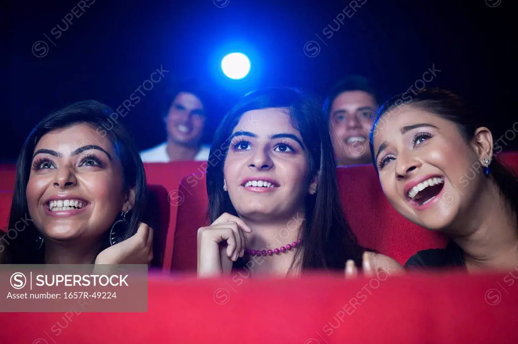 Youngsters enjoying movie in a cinema hall