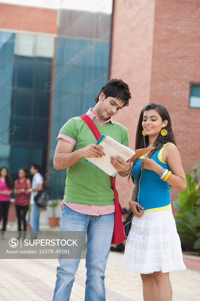 University students reading a book in university campus