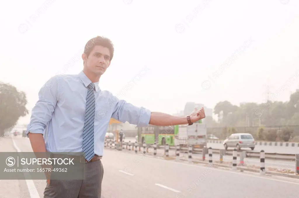 Businessman hitchhiking, Gurgaon, Haryana, India