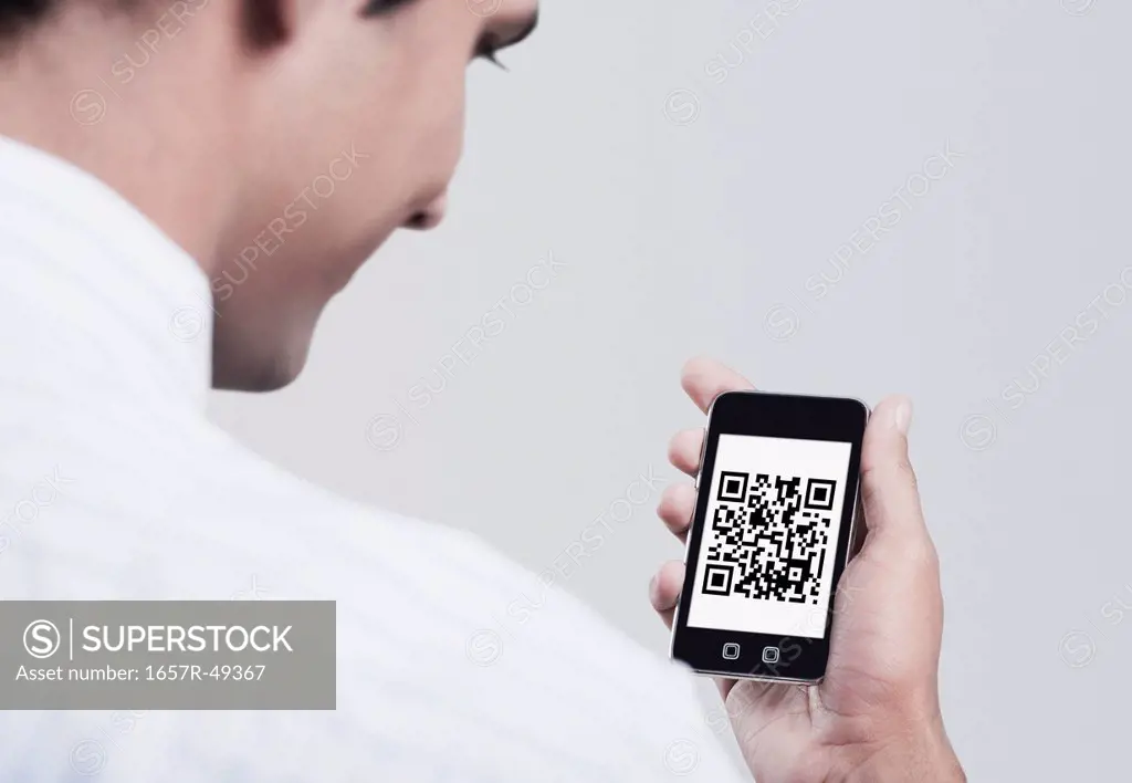 Man looking at the 2D Barcode on a mobile phone