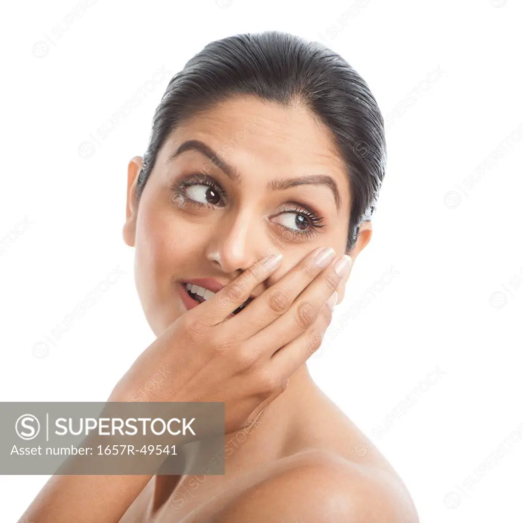 Woman covering her mouth with her hands and smiling