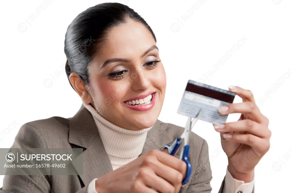 Businesswoman cutting a credit card