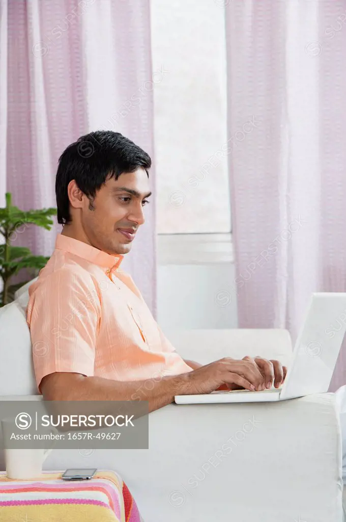 Bengali man using a laptop