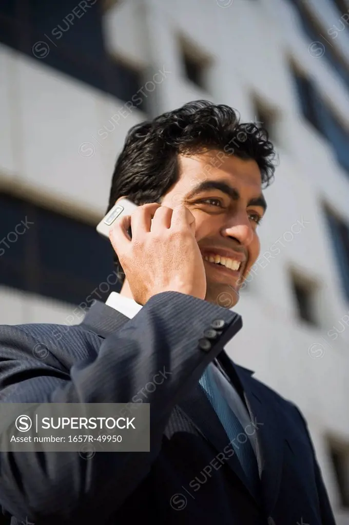 Businessman talking on a mobile phone, Gurgaon, Haryana, India
