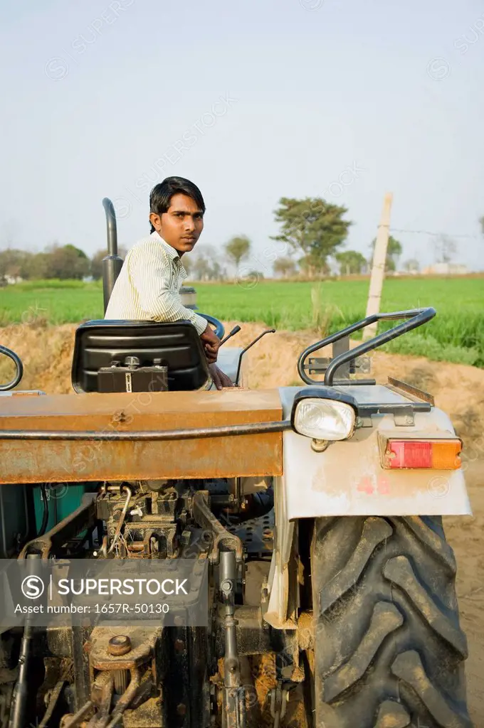 Farmer driving a tractor, Farrukh Nagar, Gurgaon, Haryana, India