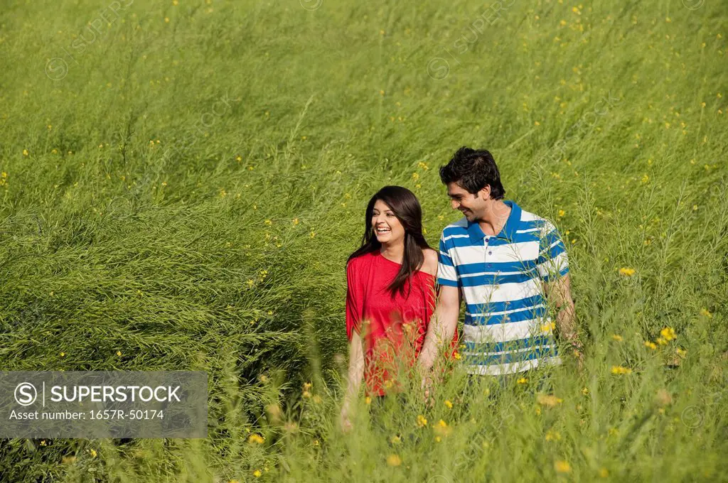 Couple enjoying in an oilseed rape field