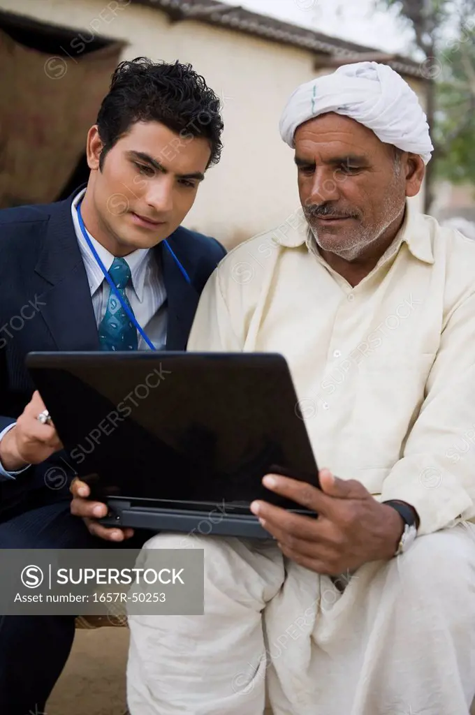 Financial advisor explaining to a farmer about agriculture loan, Hasanpur, Haryana, India