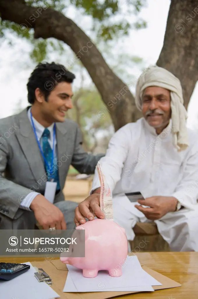Financial advisor explaining to a farmer about agriculture loan, Hasanpur, Haryana, India