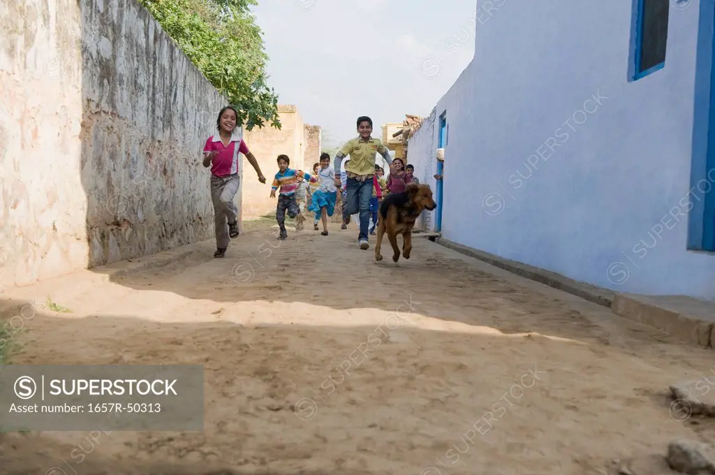 Children running in a street, Hasanpur, Haryana, India