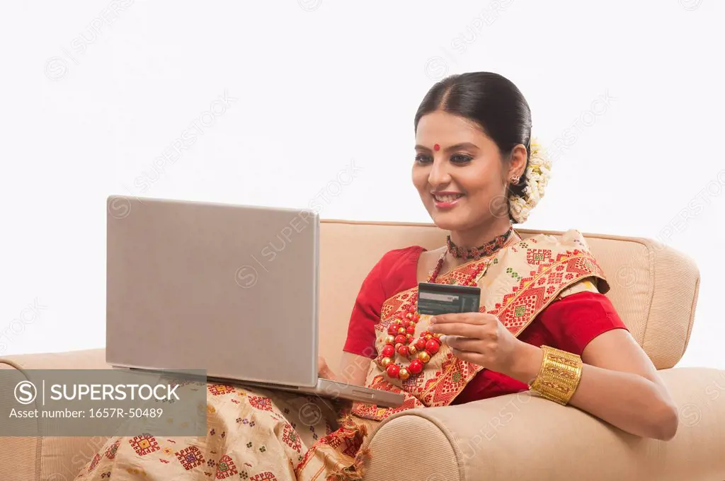 Woman doing online shopping with a laptop