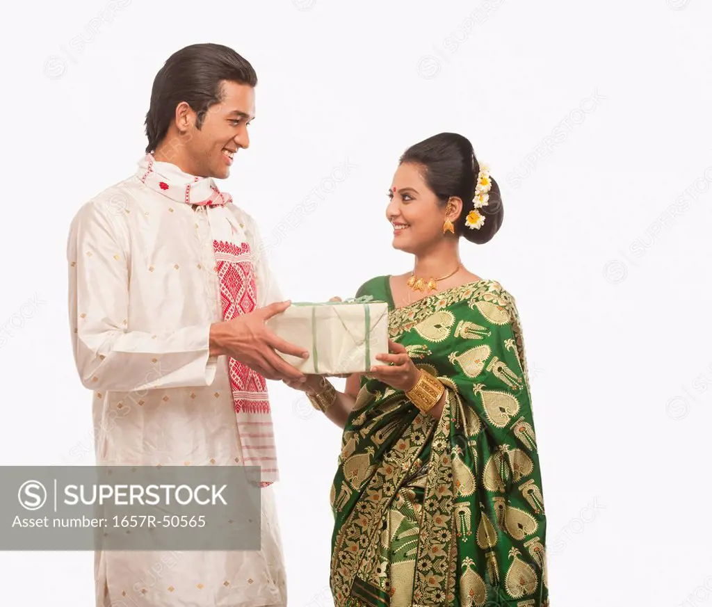 Man giving a present to a woman on Bihu festival