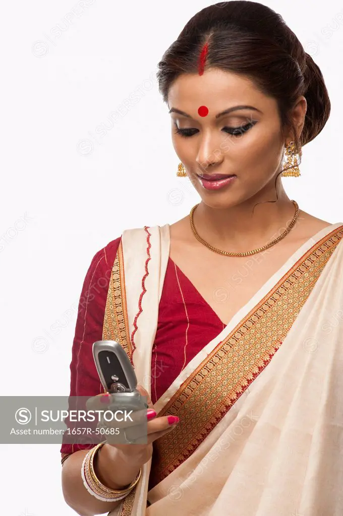 Bengali woman text messaging on a mobile phone