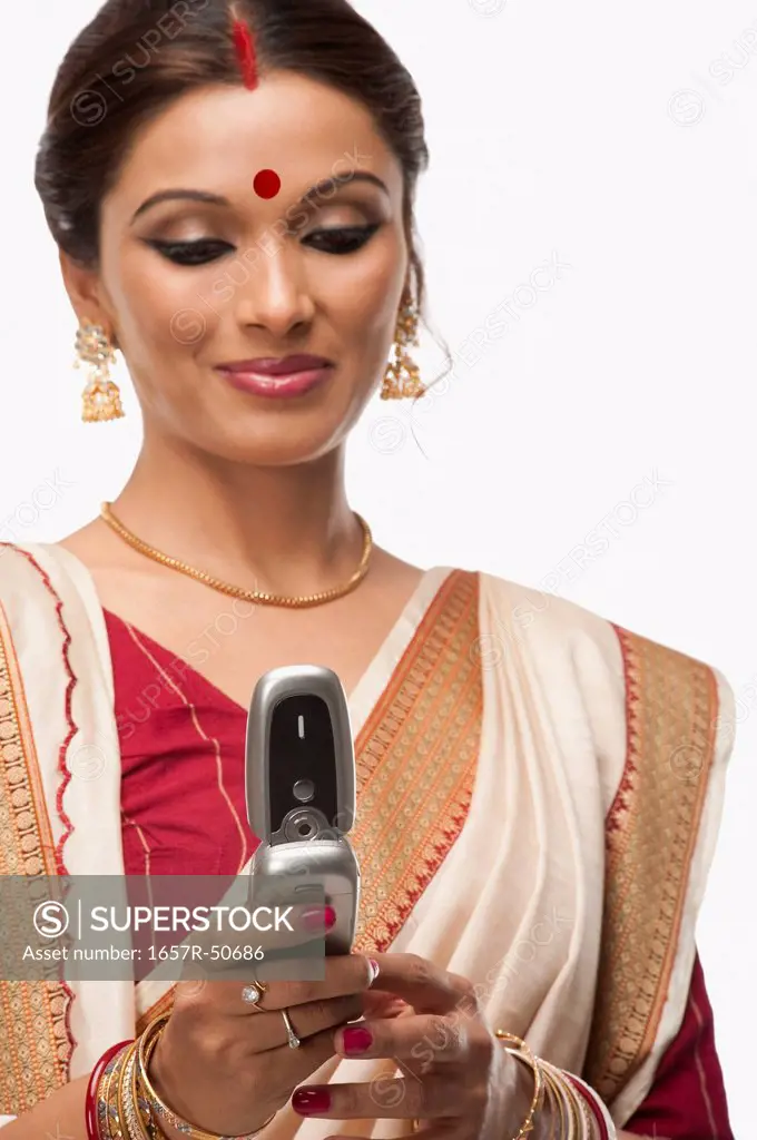 Bengali woman text messaging on a mobile phone