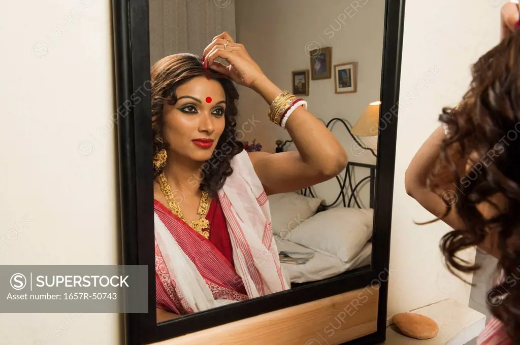 Bengali woman applying make-up