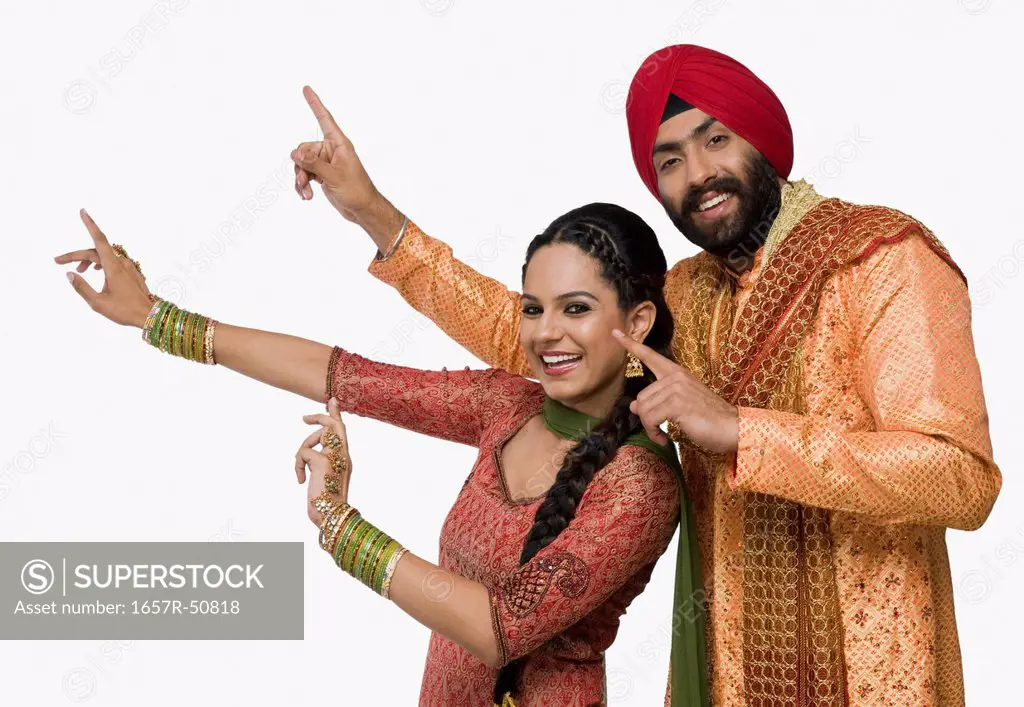 Sikh couple doing Bhangra the folk dance of Punjab in India