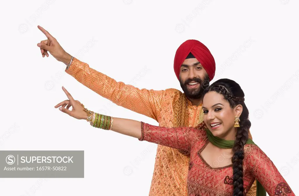 Sikh couple doing Bhangra the folk dance of Punjab in India