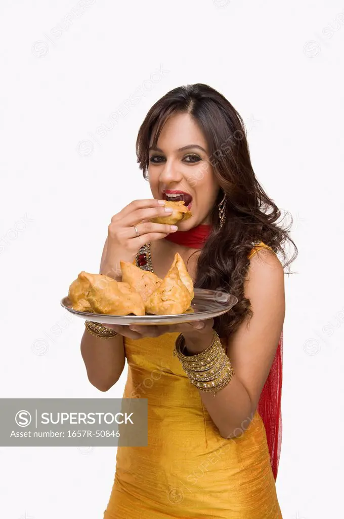 Woman eating samosa the traditional Indian snack