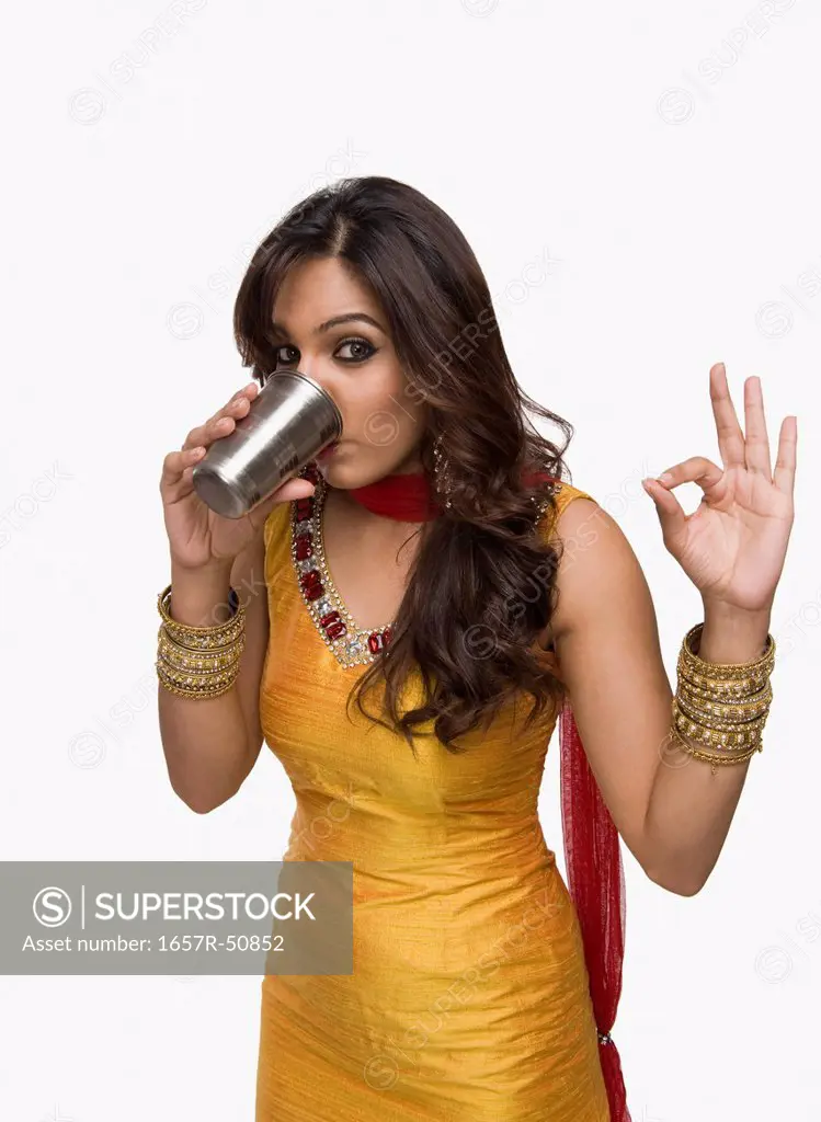 Woman drinking lassi the traditional Indian beverage