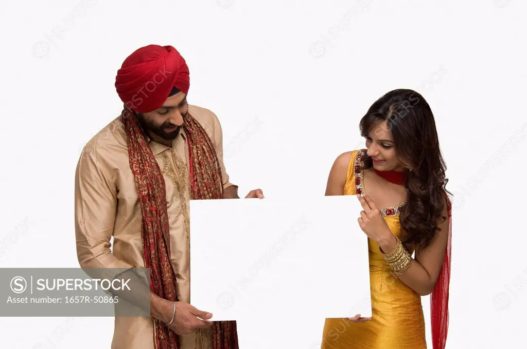 Sikh couple holding blank placard