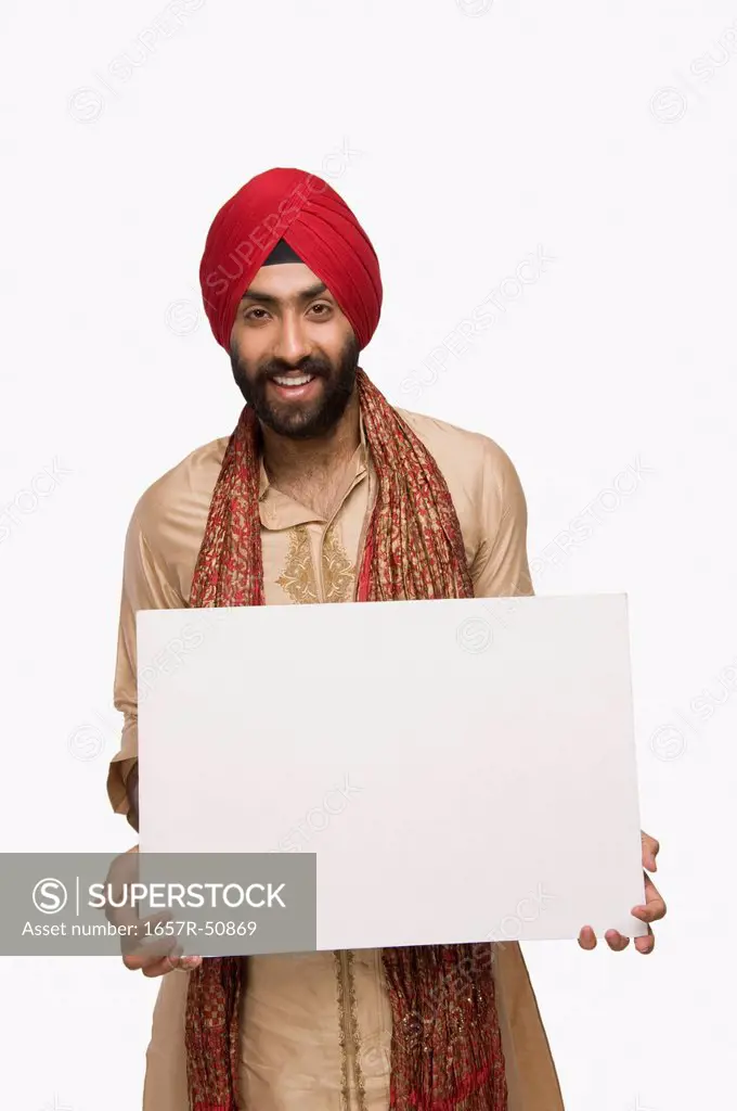 Sikh man holding a blank placard