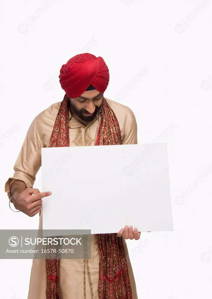 Sikh man showing a blank placard