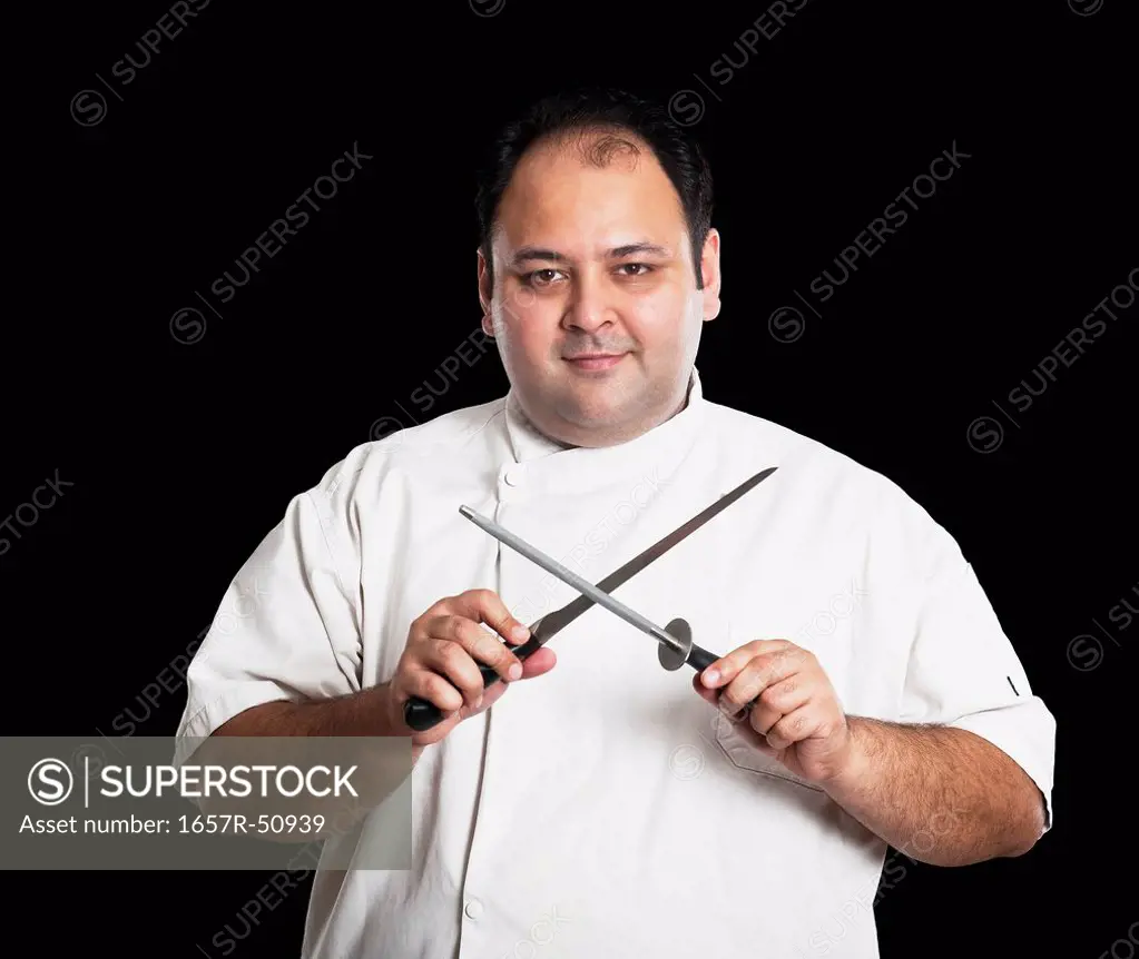 Portrait of a chef sharpening knives