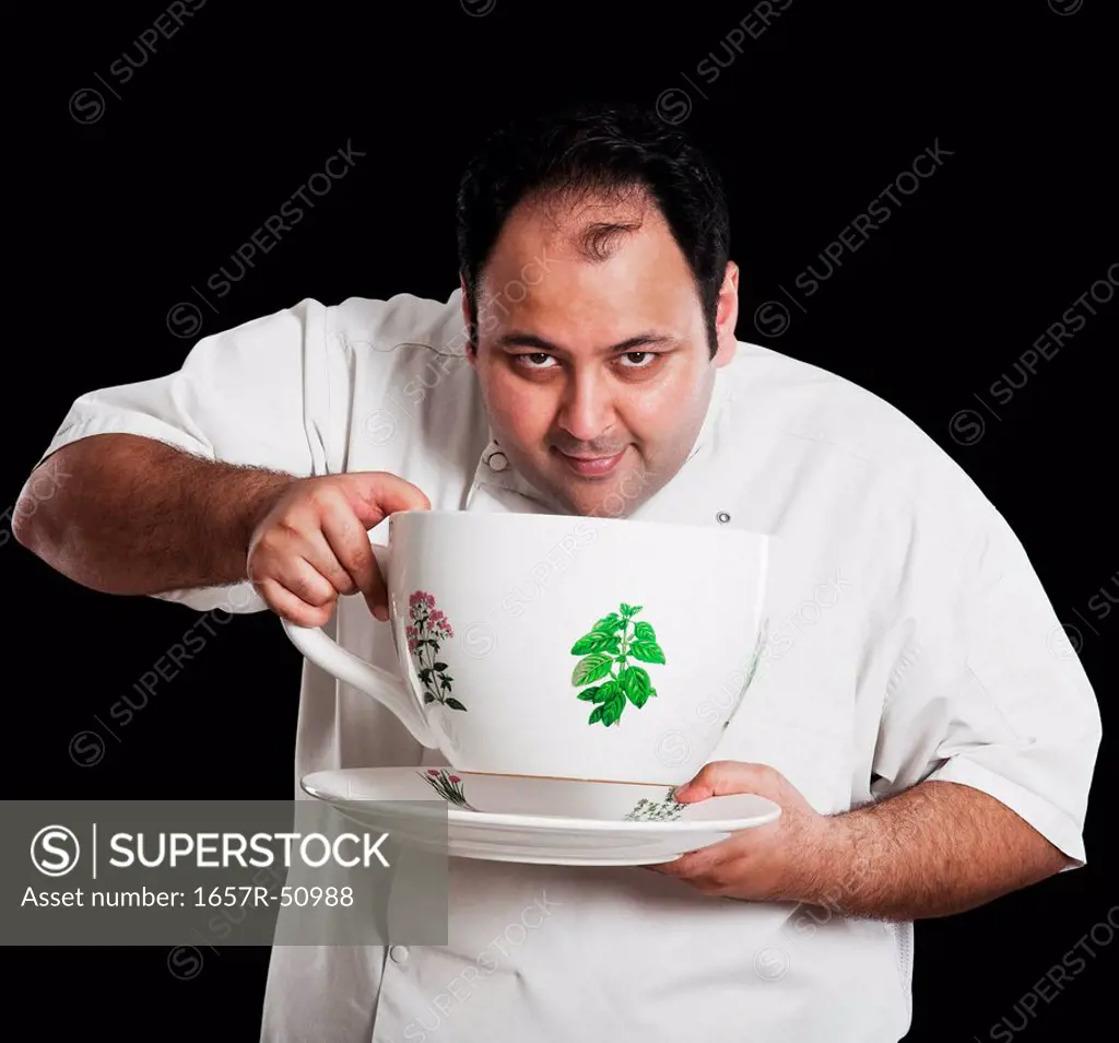 Chef drinking from an oversized cup