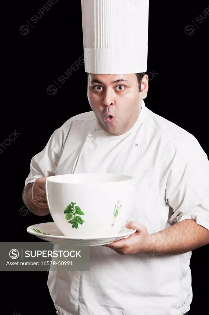 Chef looking surprised with an oversized cup
