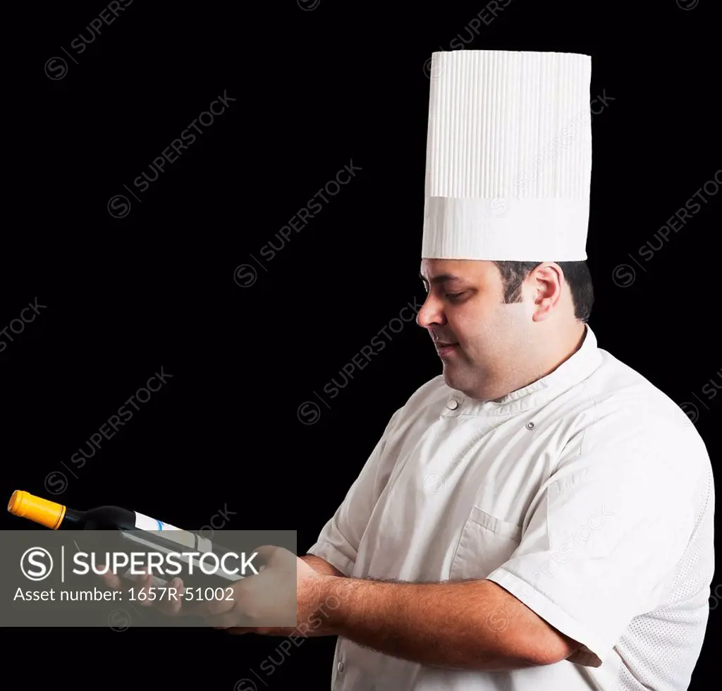 Chef looking at wine bottle