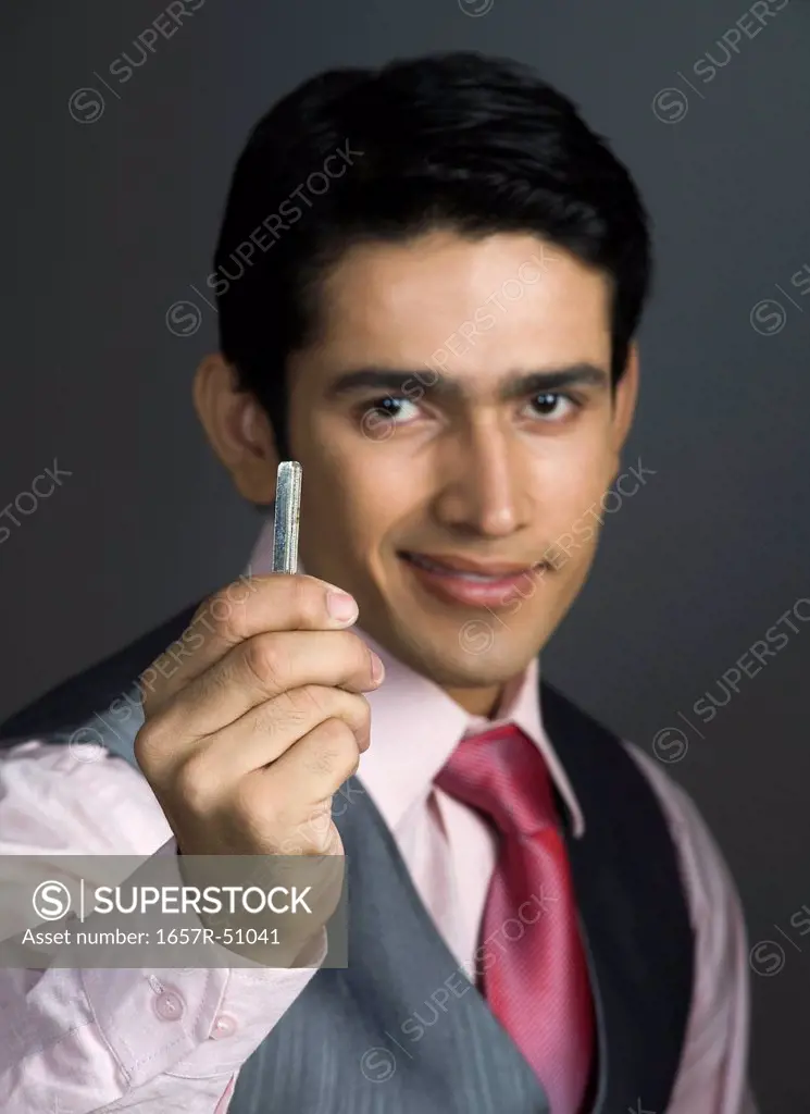 Portrait of a businessman holding a rolled up paper