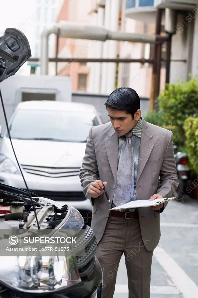 Insurance adjuster inspecting a car