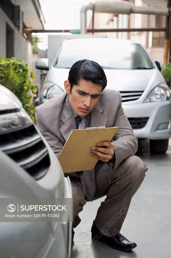 Insurance adjuster inspecting a car