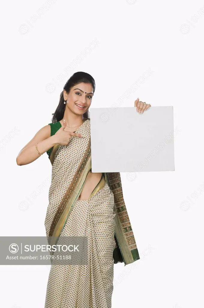 Woman pointing at a whiteboard and smiling