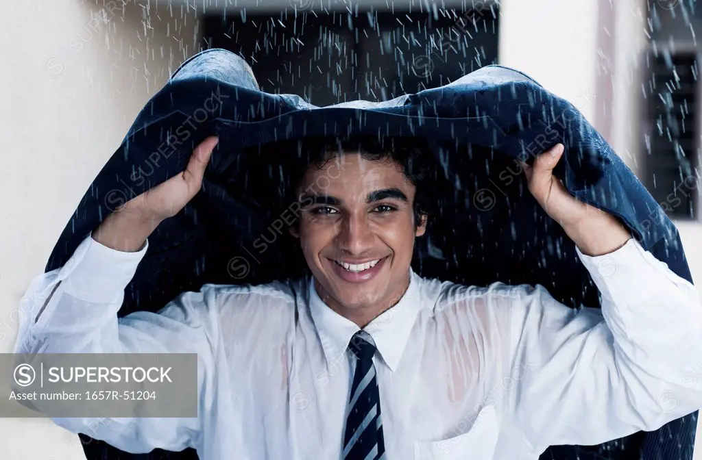 Businessman enjoying the rain