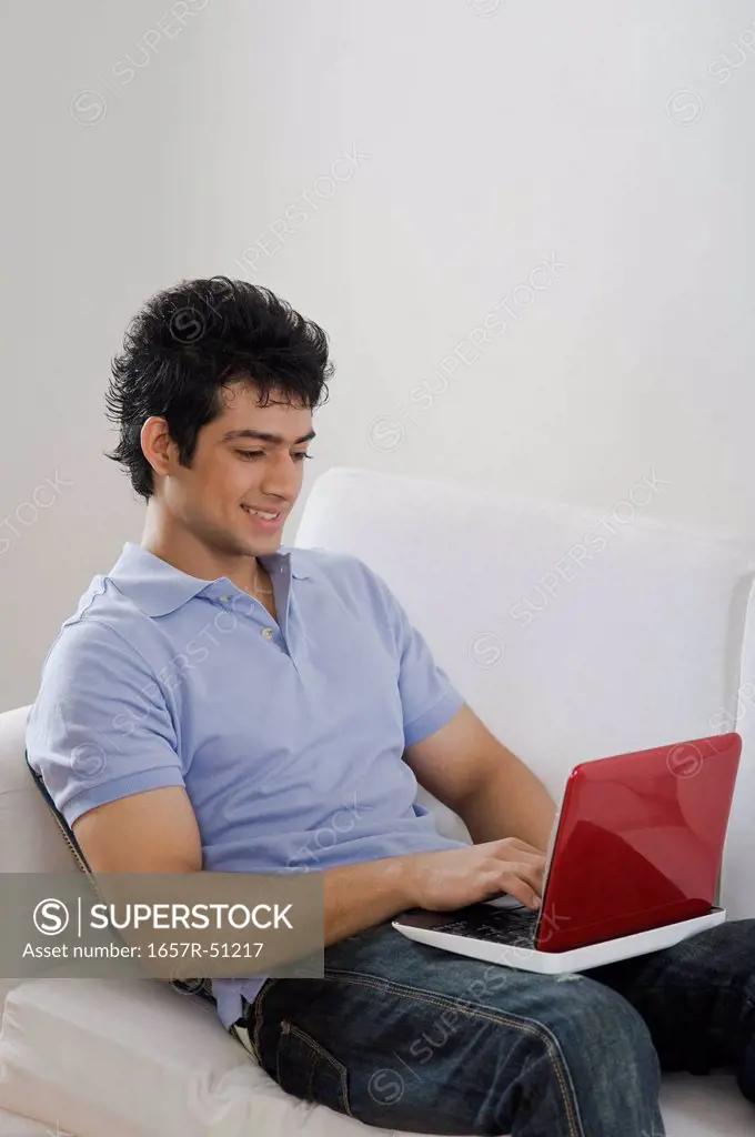 Man using a laptop on a couch
