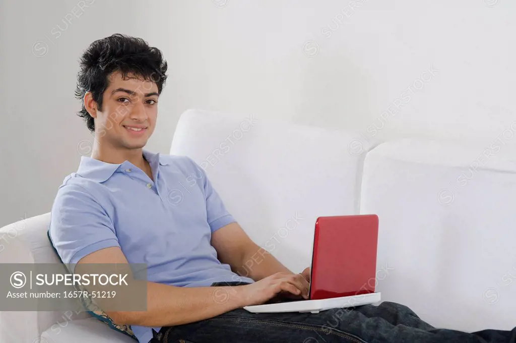 Man using a laptop on a couch