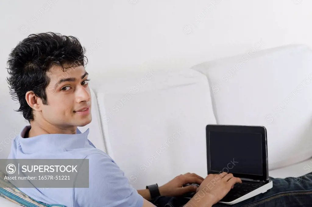 Man using a laptop on a couch