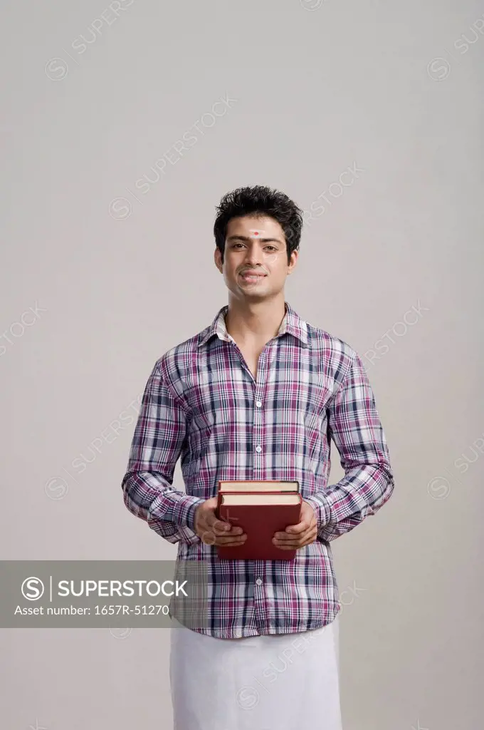 Portrait of an university student holding books