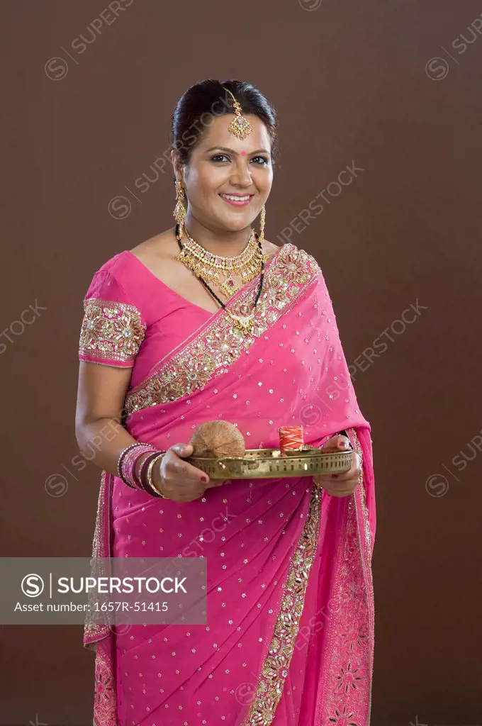 Portrait of a woman in sari holding religious offering