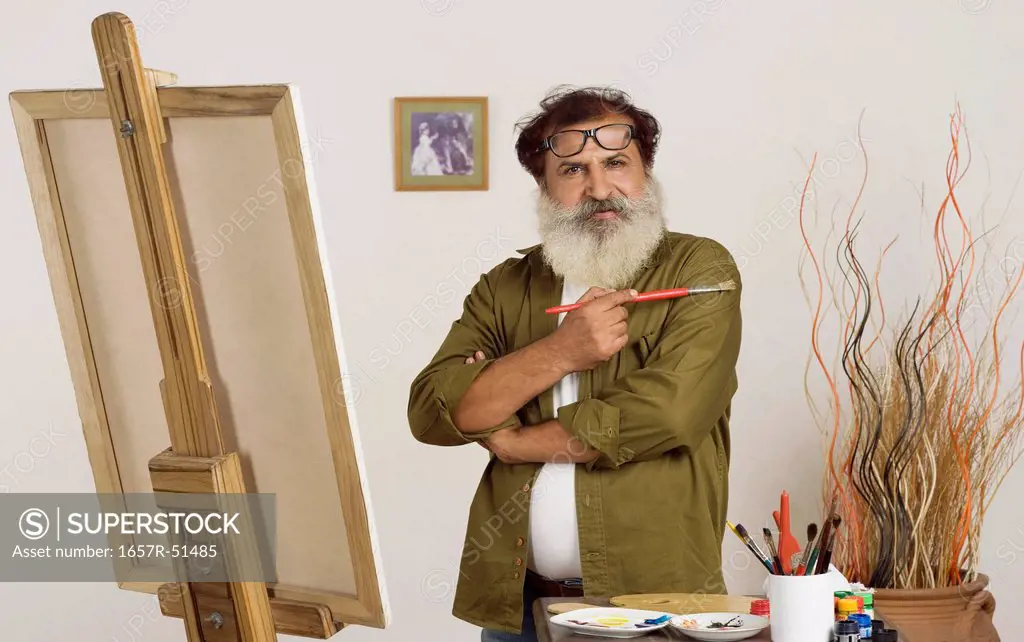 Portrait of a painter holding a paintbrush