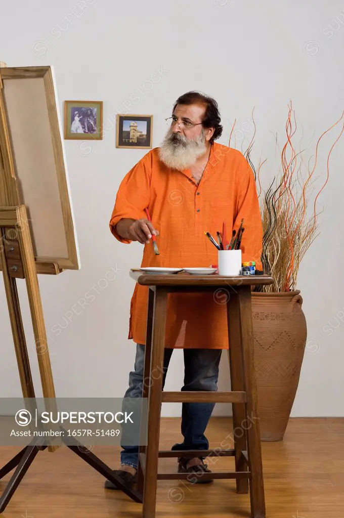 Painter looking at canvas
