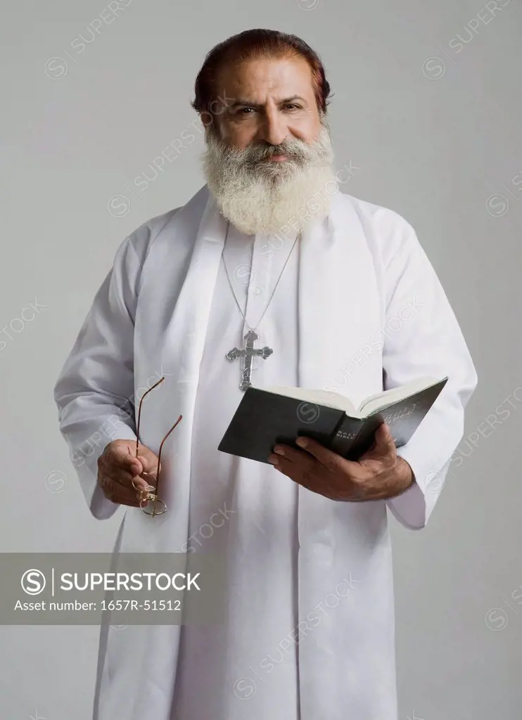 Priest holding a holy book
