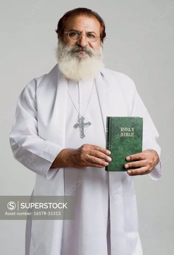 Priest showing a Bible