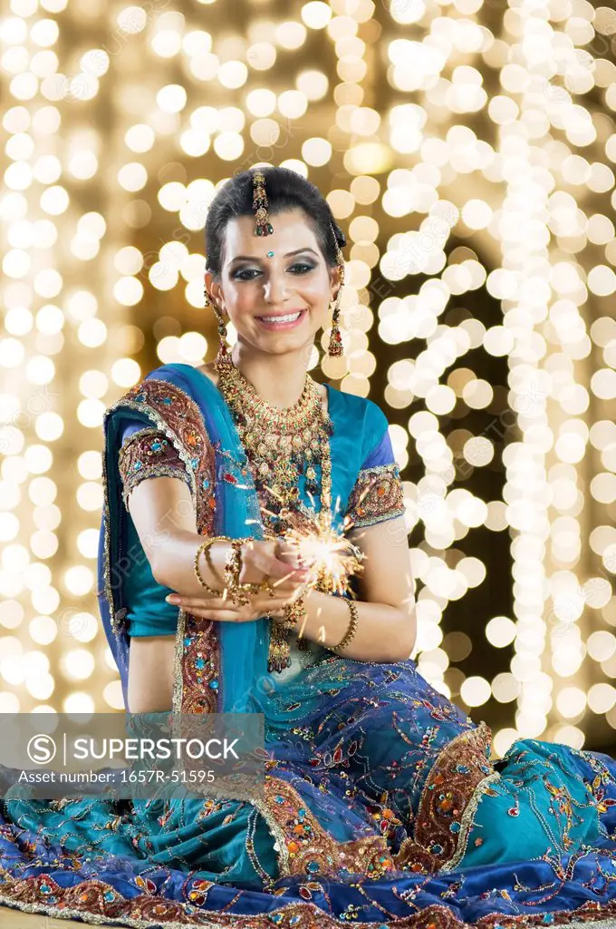 Woman celebrating Diwali festival with a sparkler