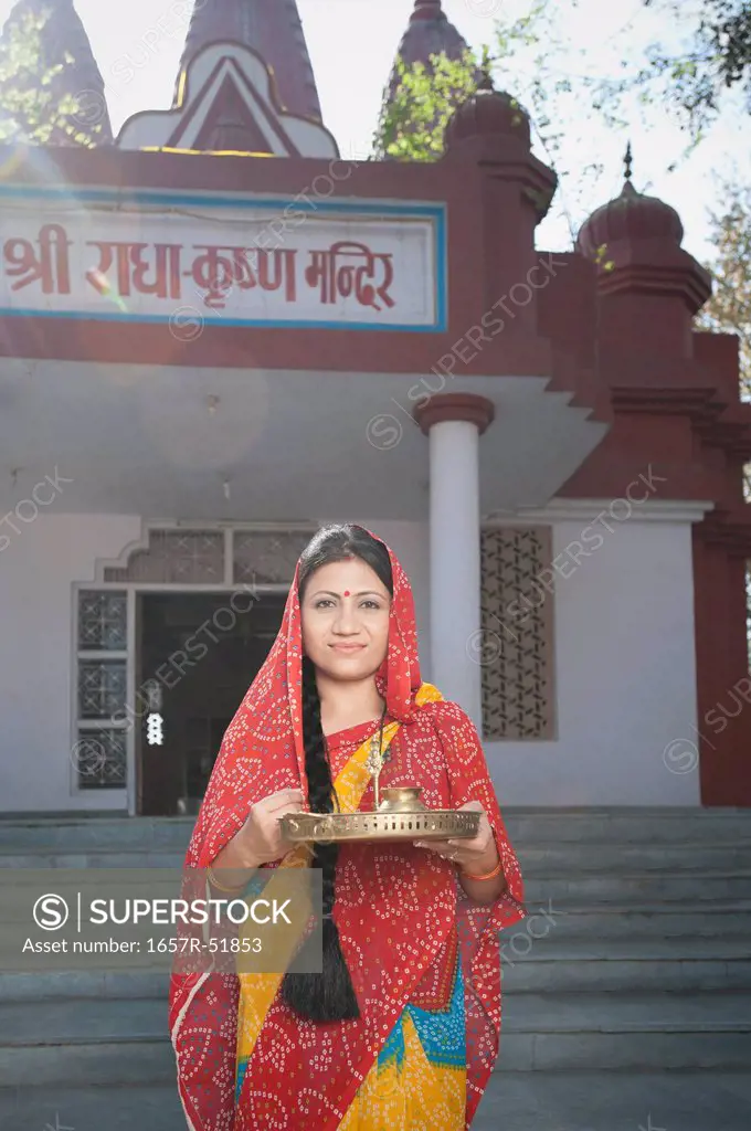 Woman standing in front of a temple, Sohna, Haryana, India