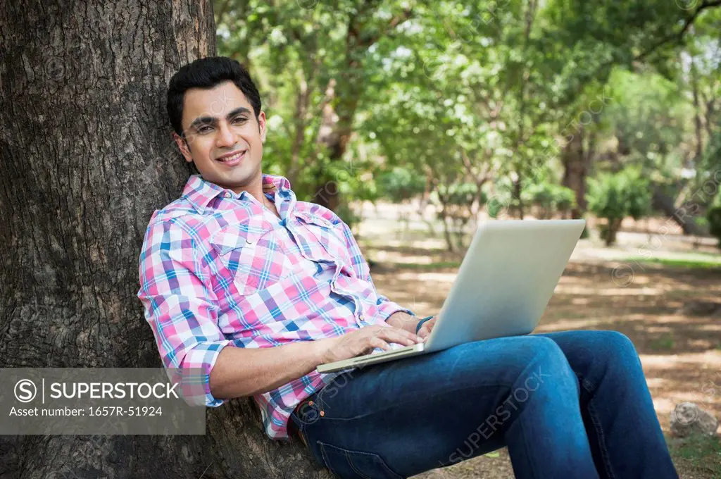 Man using a laptop in a park, Lodi Gardens, New Delhi, Delhi, India