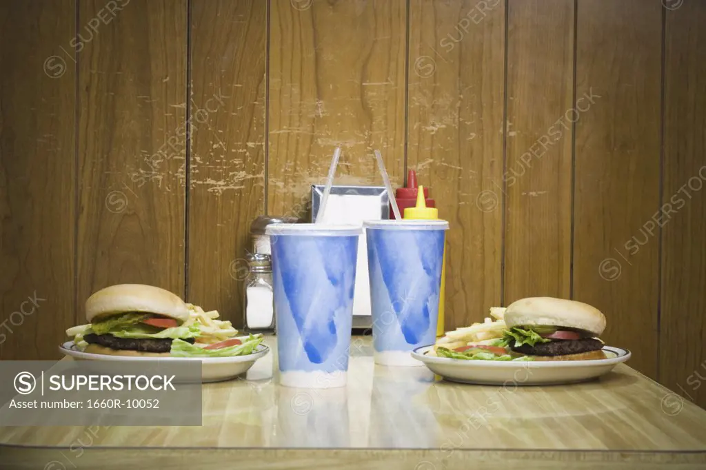 Close-up of cold drinks and burgers on the table