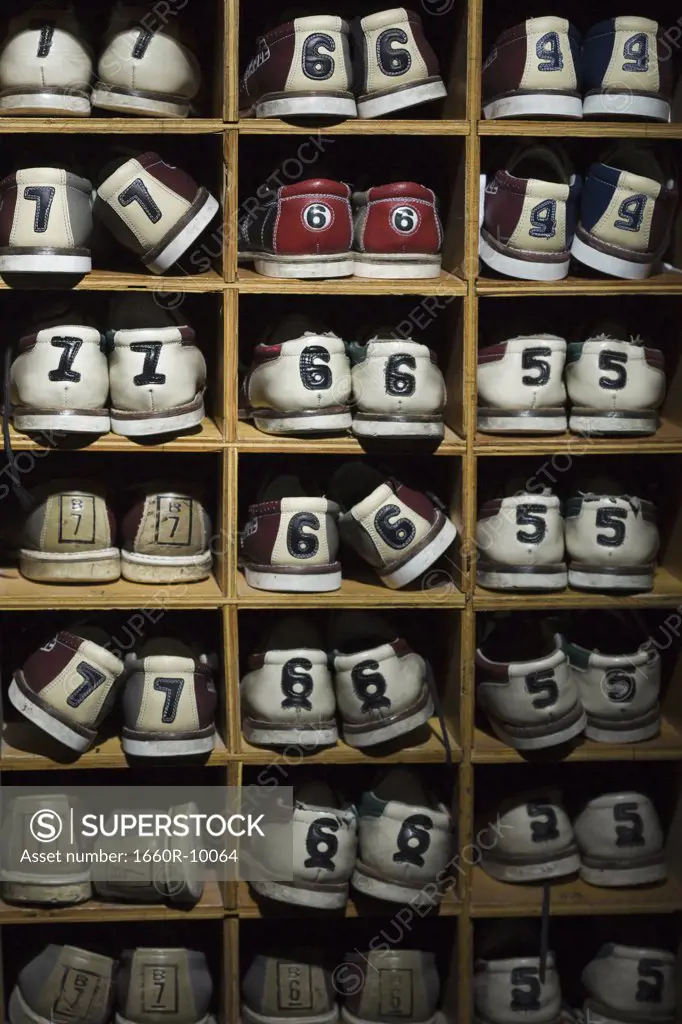 Pairs of bowling shoes on a shelf